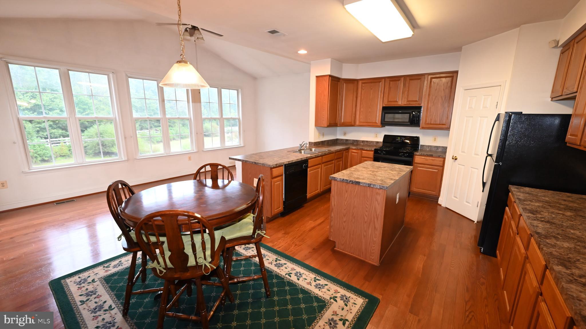 11258 Wildmeadows Street Waldorf, MD 20601 - Photo 2 of 33 a view of a dining room with furniture window and wooden floor