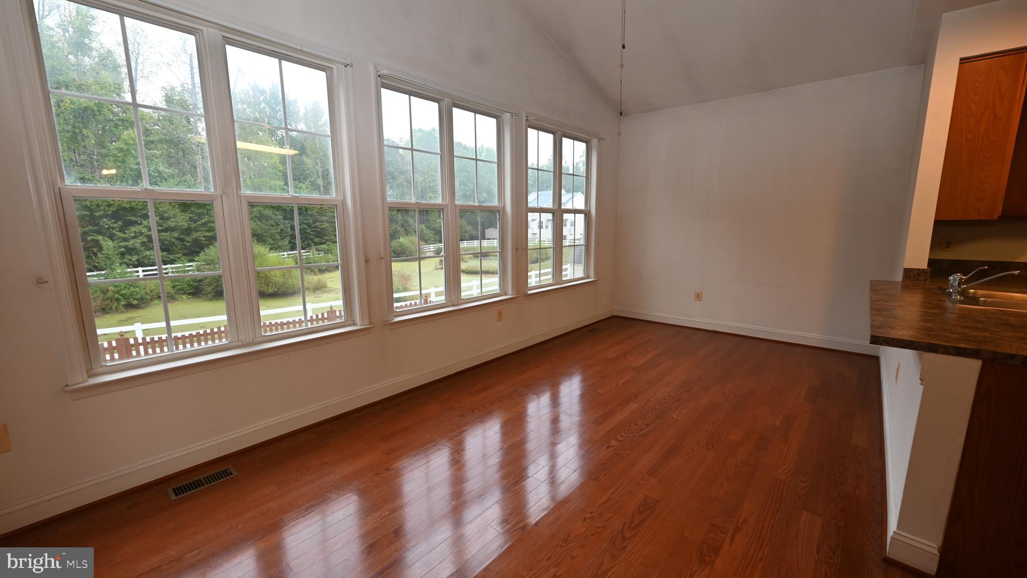 11258 Wildmeadows Street Waldorf, MD 20601 - Photo 5 of 33 a view of an empty room with wooden floor and a window