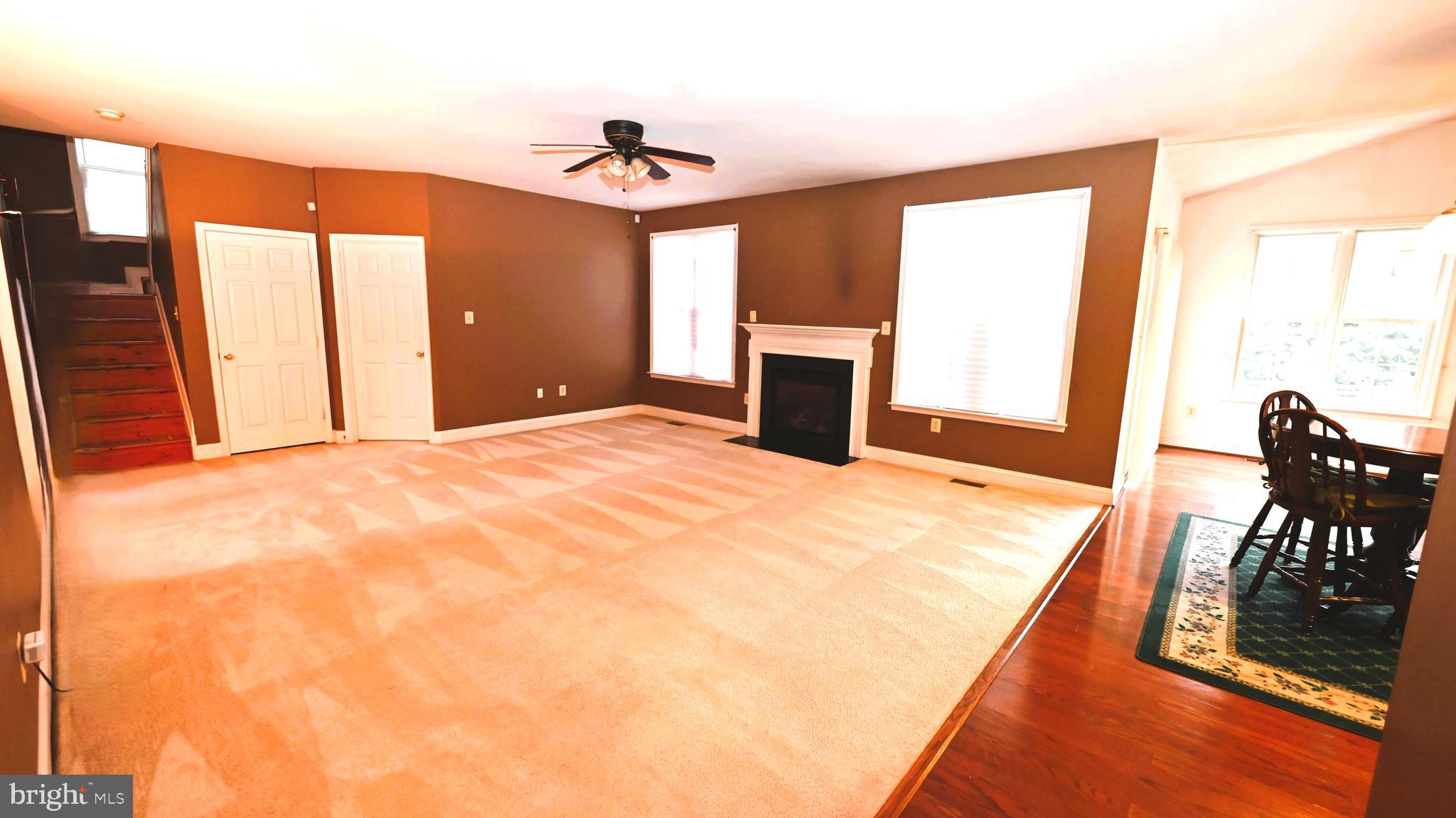 11258 Wildmeadows Street Waldorf, MD 20601 - Photo 9 of 33 a view of a livingroom with a fireplace and a window