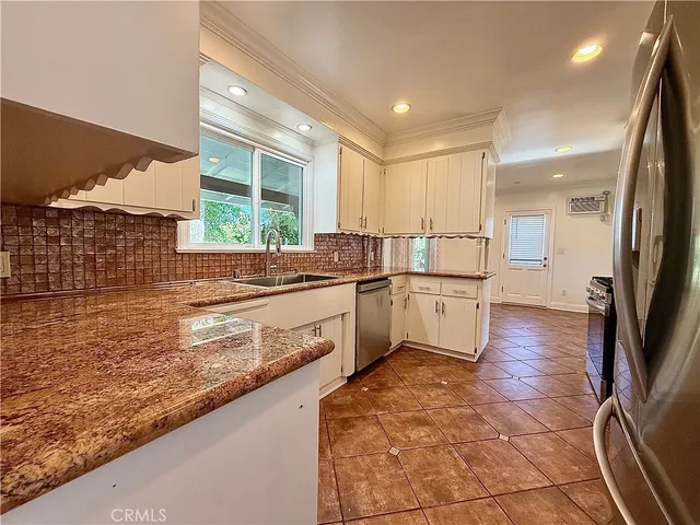 a kitchen with a refrigerator and a stove