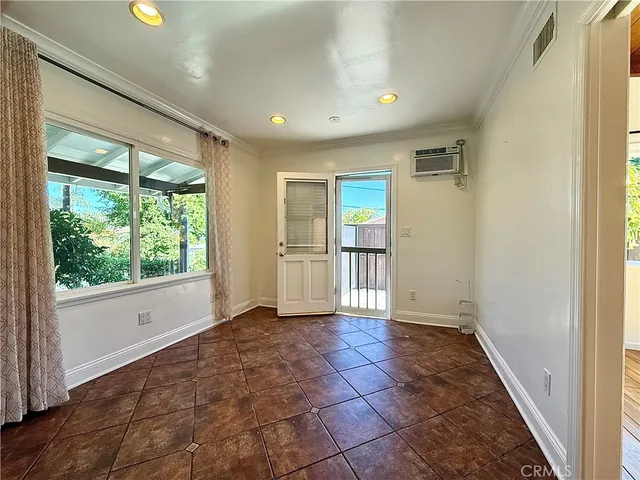 a view of a room with wooden floor and white walls