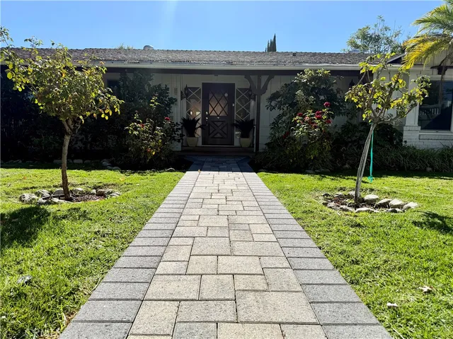 a view of a backyard with potted plants