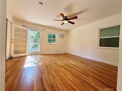 a view of an empty room with wooden floor