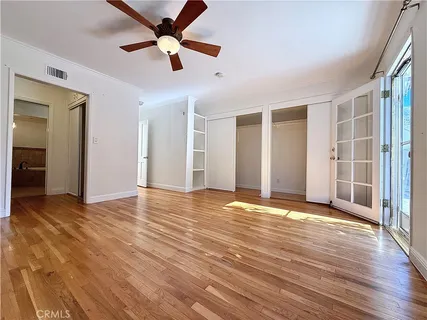 a view of a room with wooden floor