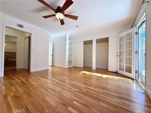 a view of a room with wooden floor