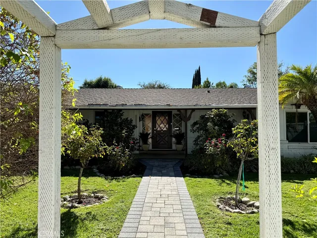 a view of a patio with table and chairs and potted plants