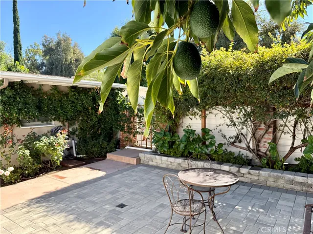a view of a backyard with sitting area
