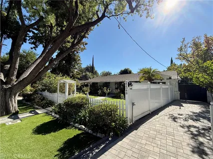 a view of a house with a backyard and garden
