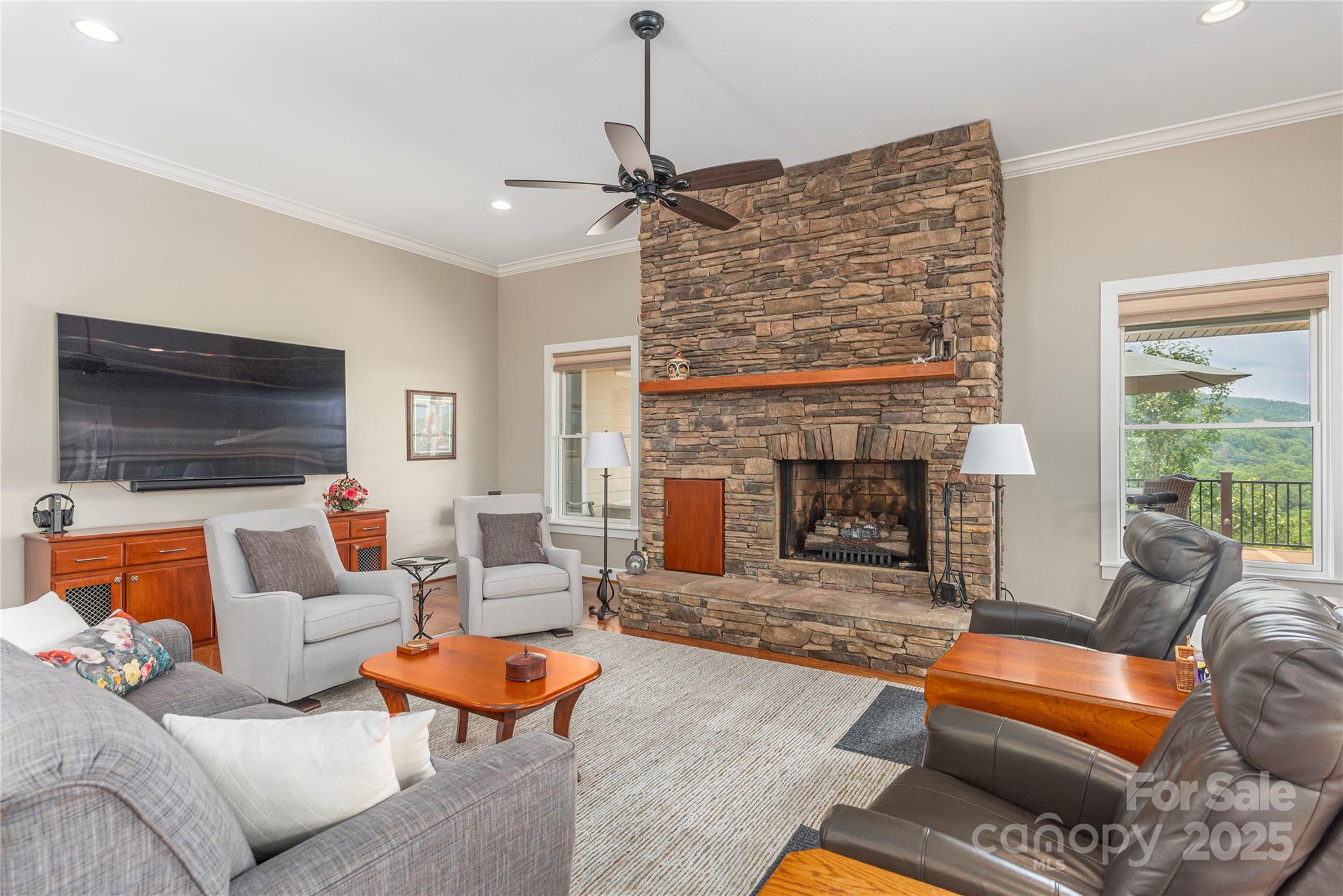 930 Big Raven Lane Saluda, NC 28773 - Photo 11 of 35 a living room with furniture a flat screen tv and a fireplace