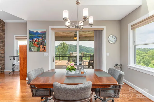 a dining room with furniture a rug and wooden floor