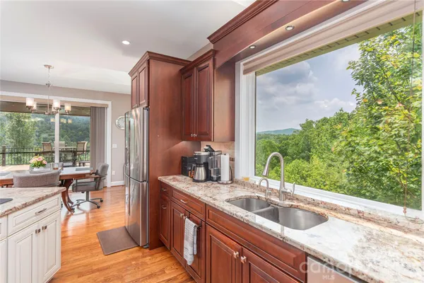 a kitchen with kitchen island a large window in it