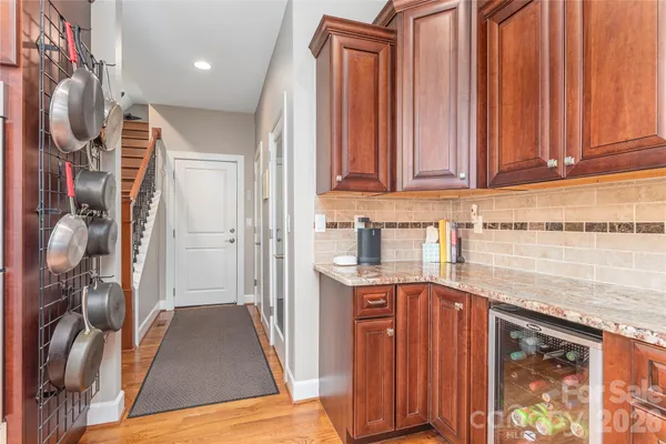 a kitchen with stainless steel appliances granite countertop a refrigerator and a stove