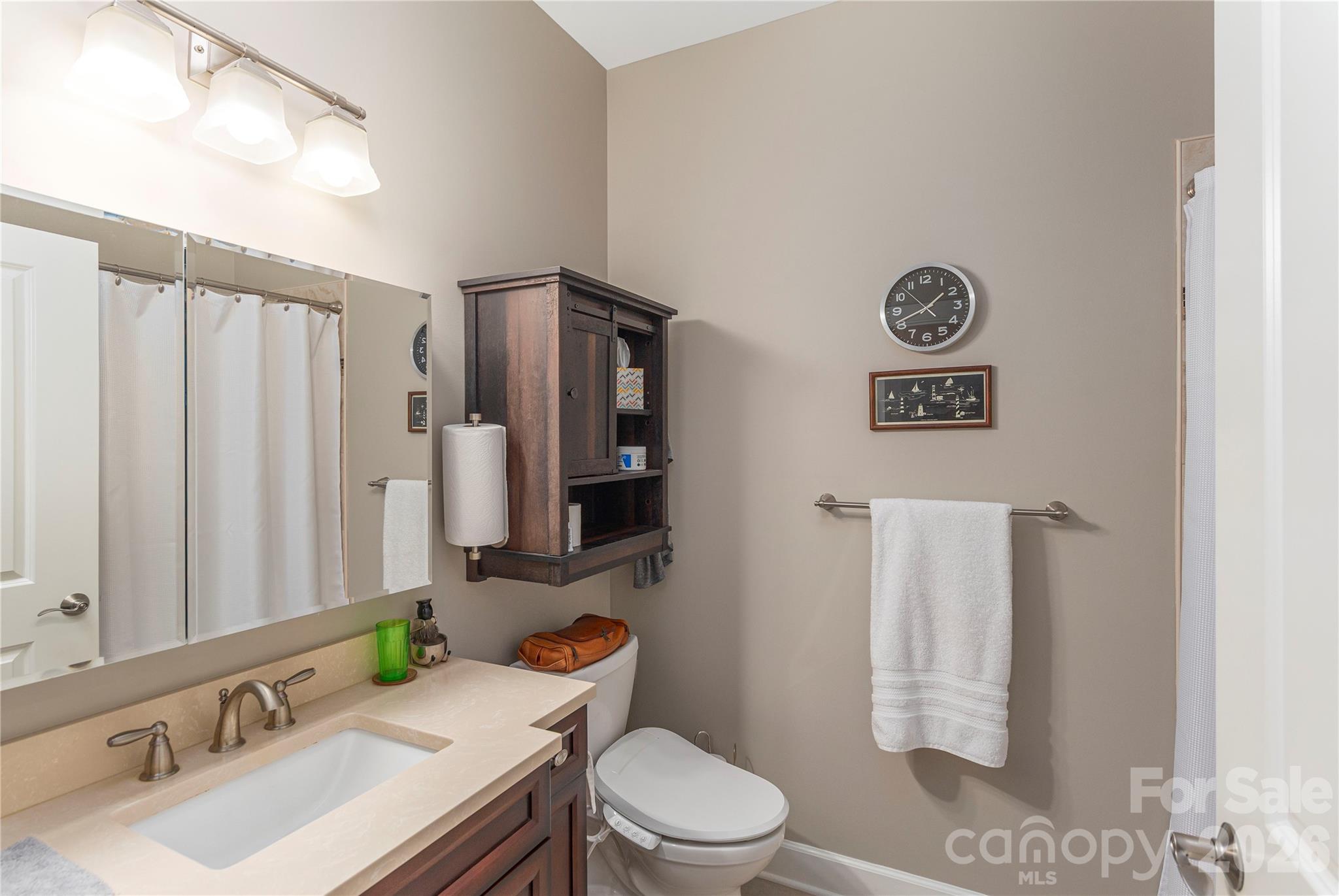 930 Big Raven Lane Saluda, NC 28773 - Photo 18 of 35 a bathroom with a sink toilet and mirror