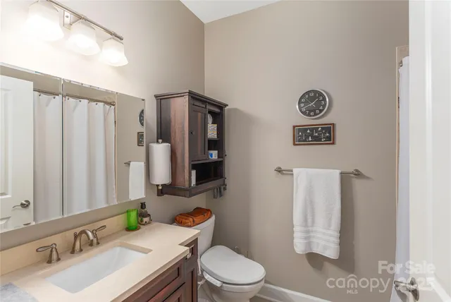 a bathroom with a sink toilet and mirror