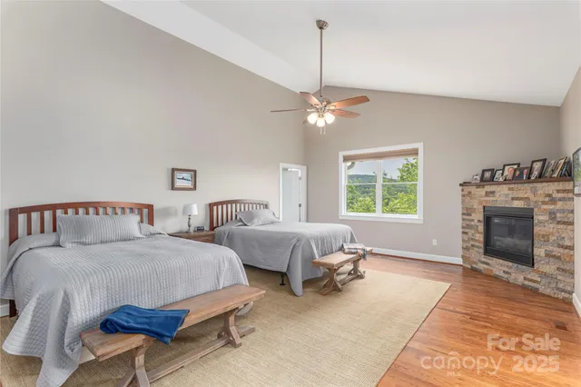 a spacious bedroom with a bed and a fireplace