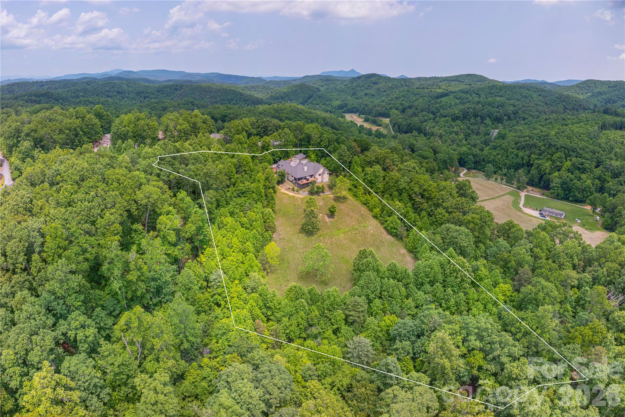 930 Big Raven Lane Saluda, NC 28773 - Photo 2 of 35 a view of a city with lush green forest
