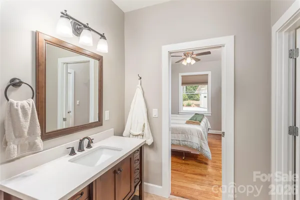 a bathroom with a sink vanity and a mirror