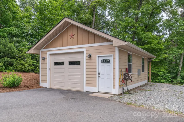 a view of a small house with garage
