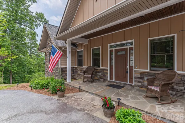 a front view of a house with outdoor seating and a potted plant