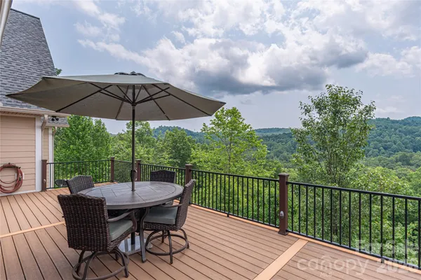 a table and chairs in patio with a yard