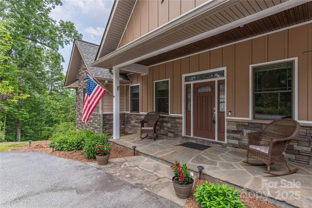 a front view of a house with outdoor seating and a potted plant
