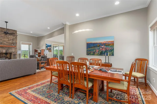 a dining room with furniture a rug and wooden floor