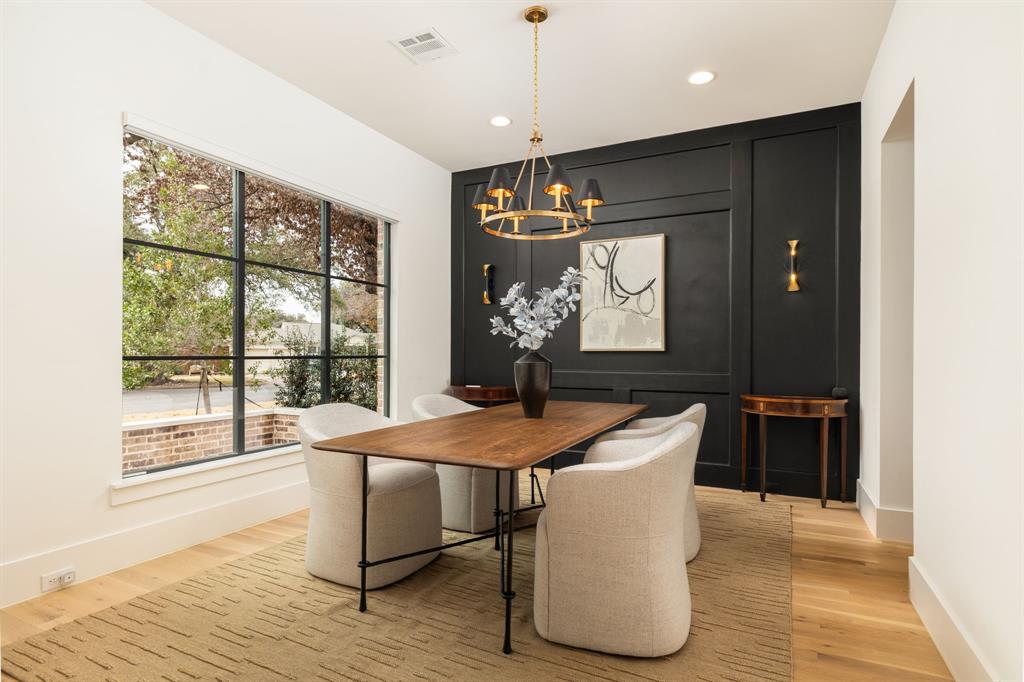 5019 Lark Lane Dallas, TX 75209 - Photo 8 of 32 a dining room with wooden floor a chandelier a wooden table and chairs