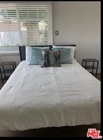 a bedroom with a bed and window