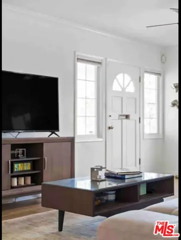 a living room with fireplace furniture and a flat screen tv