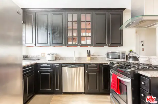 a kitchen with stainless steel appliances granite countertop a stove and a sink