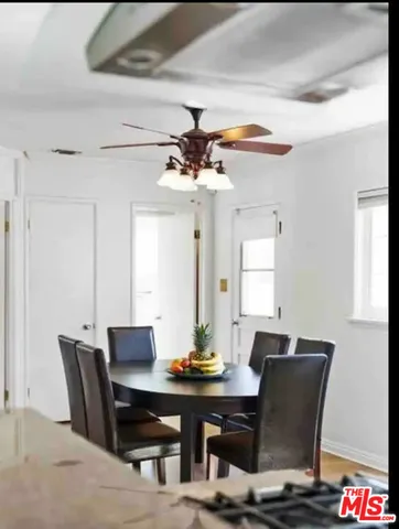 a view of a dining room with a table and chairs