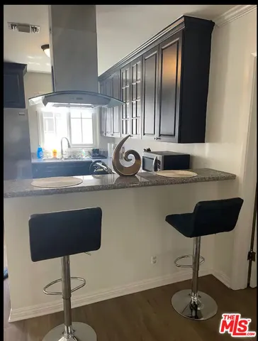 a table chair sitting in a kitchen next to a window