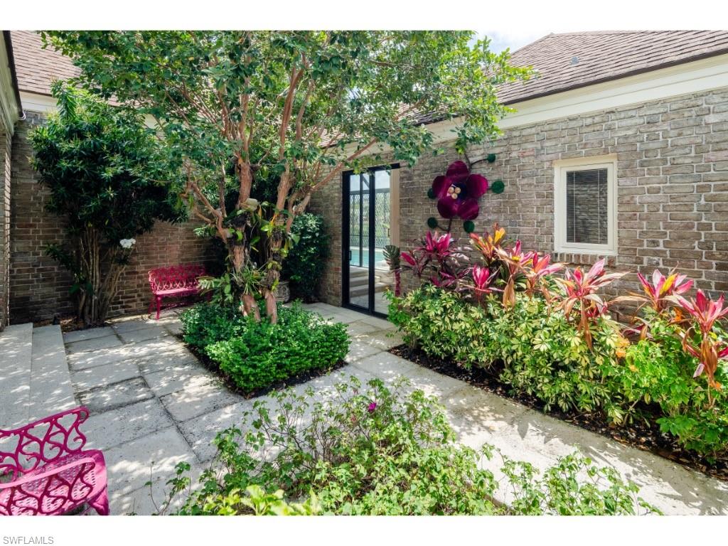 2610 Half Moon Walk Naples, FL 34102 - Photo 5 of 10 a view of a house with a yard and potted plants