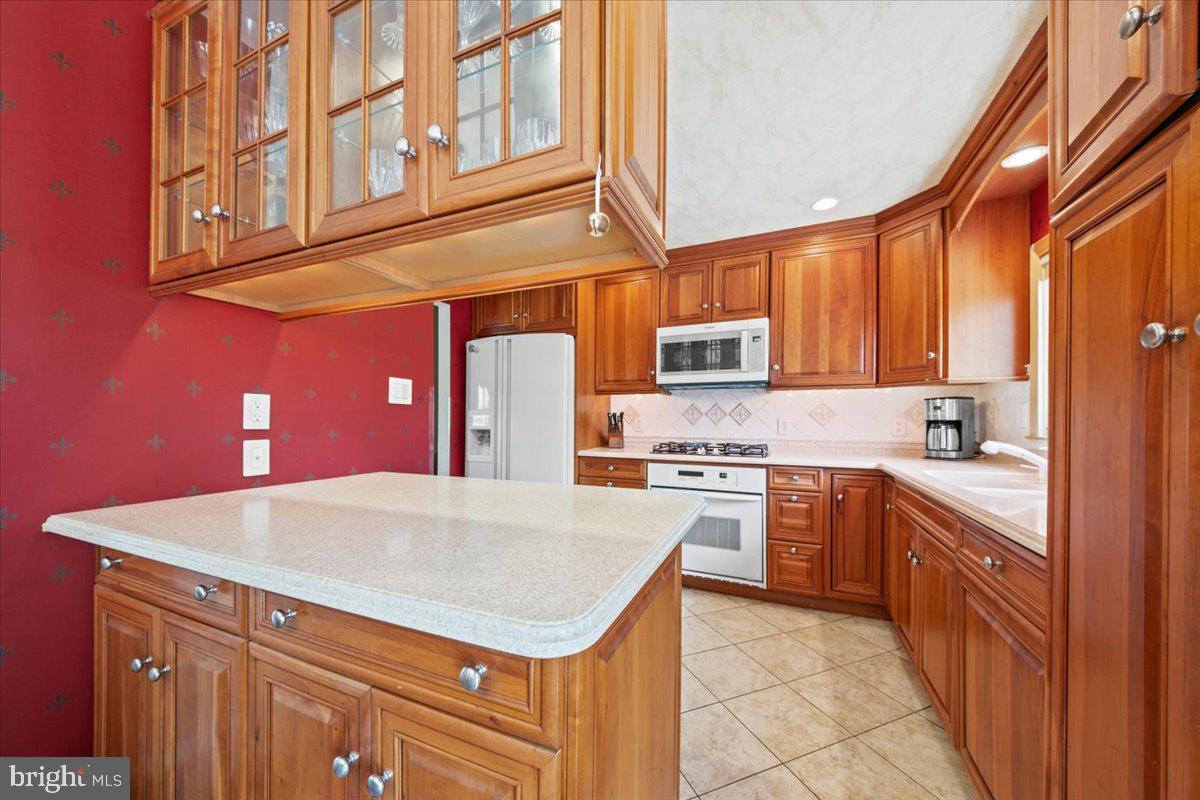 12 Green Tree Road Stratford, NJ 08084 - Photo 11 of 33 a kitchen with stainless steel appliances granite countertop a sink and cabinets