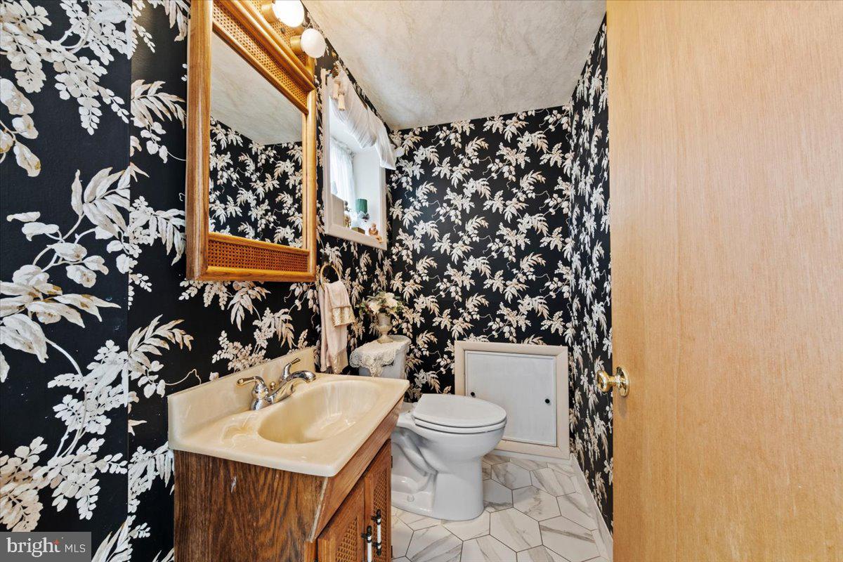 12 Green Tree Road Stratford, NJ 08084 - Photo 27 of 33 a bathroom with a sink toilet and a mirror