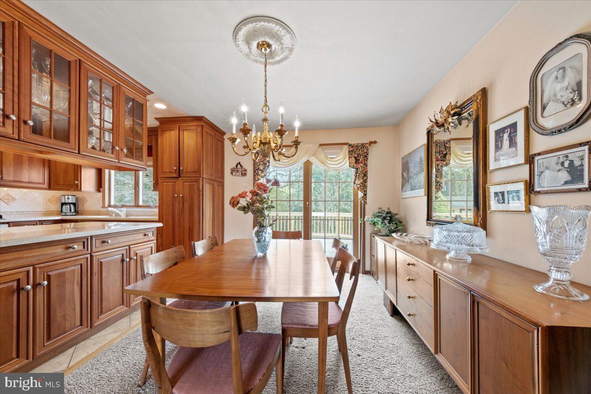 12 Green Tree Road Stratford, NJ 08084 - Photo 10 of 33 a view of a dining room with furniture a chandelier and wooden floor