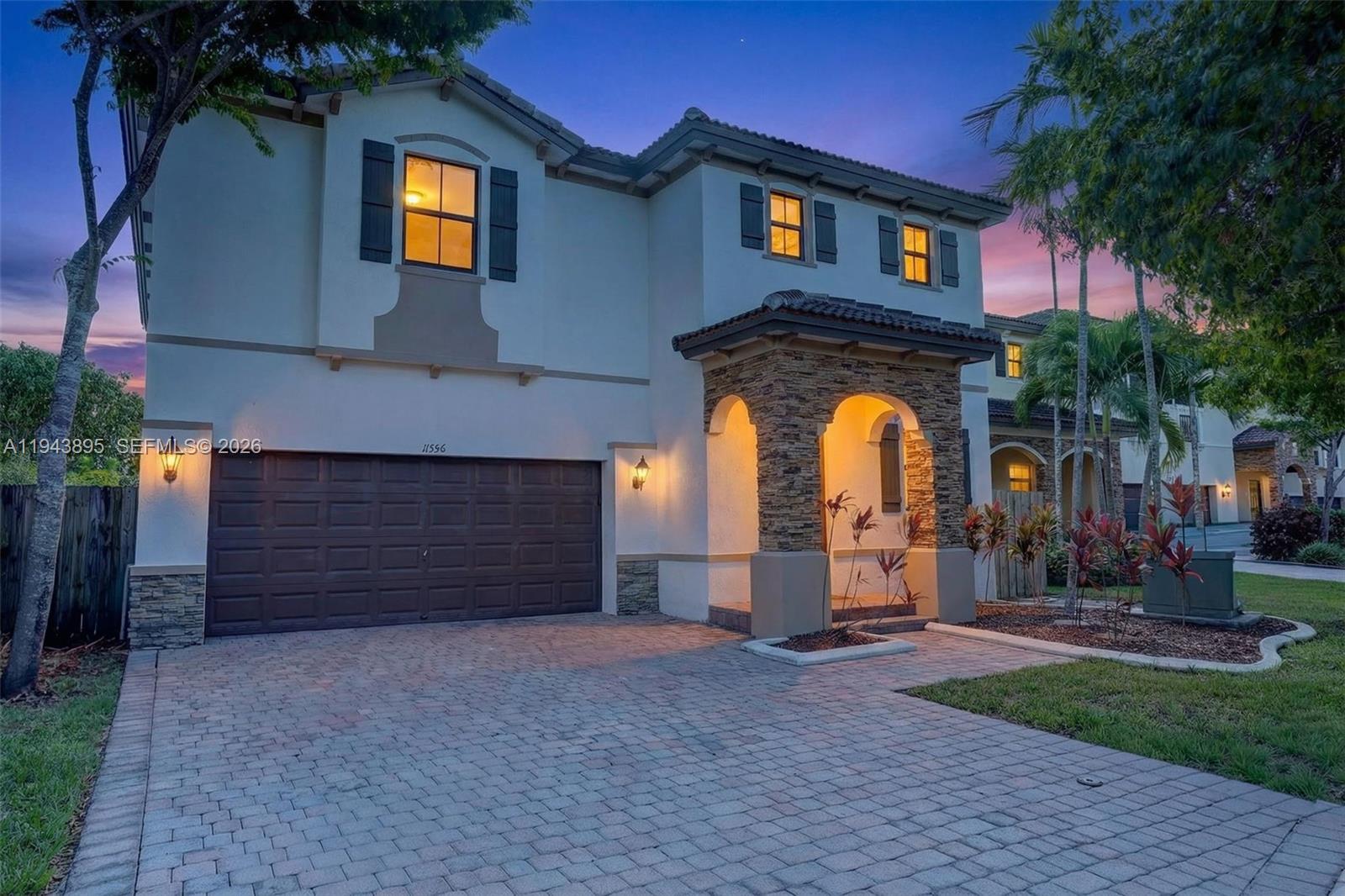 11556 Southwest 234th Street Homestead, FL 33032 - Photo 1 of 44 a front view of a house with a yard