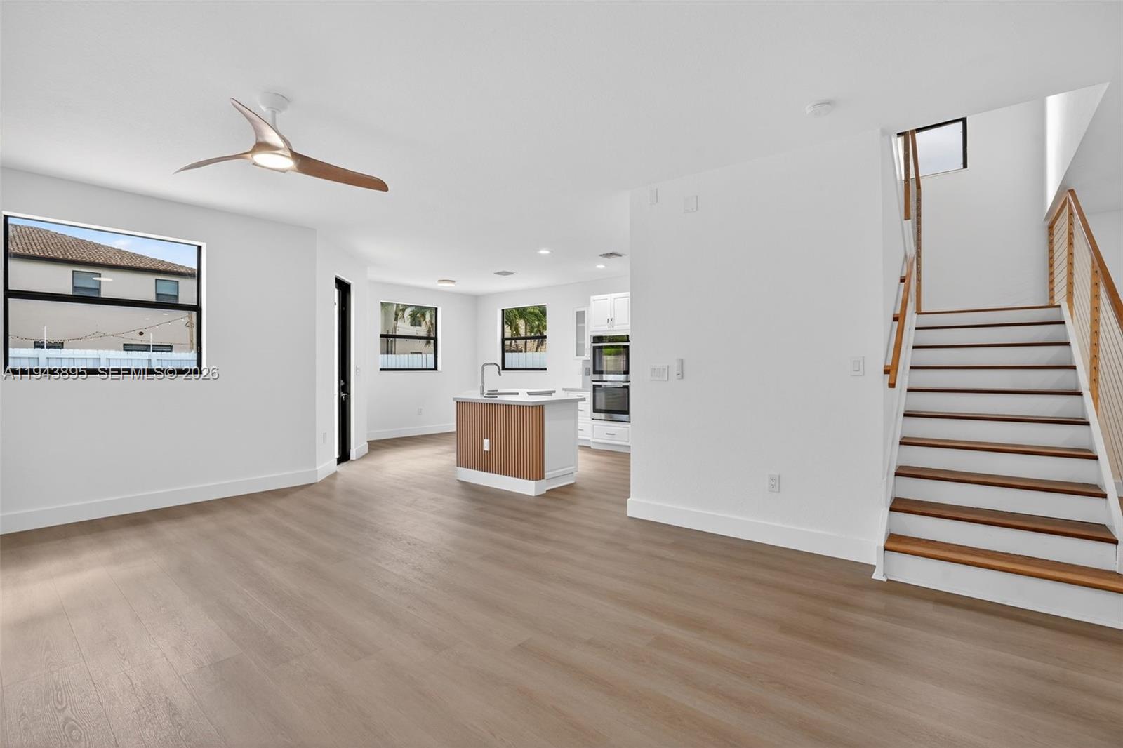 11556 Southwest 234th Street Homestead, FL 33032 - Photo 12 of 44 wooden floor in an empty room with a window