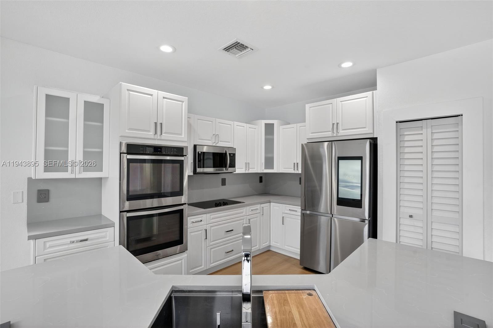 11556 Southwest 234th Street Homestead, FL 33032 - Photo 13 of 44 a kitchen with granite countertop a refrigerator stove and microwave