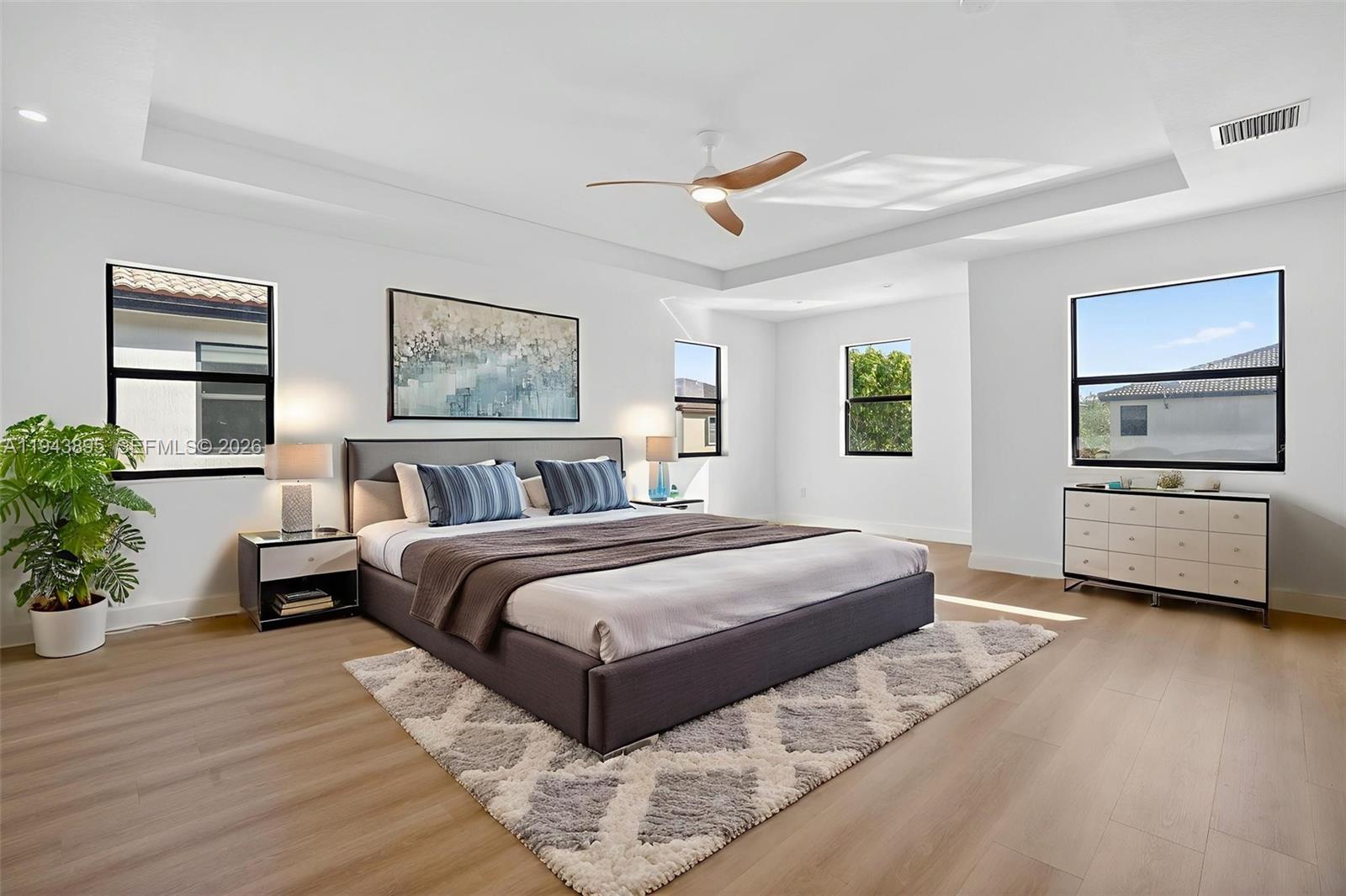 11556 Southwest 234th Street Homestead, FL 33032 - Photo 18 of 44 a bedroom with a large bed and a tv