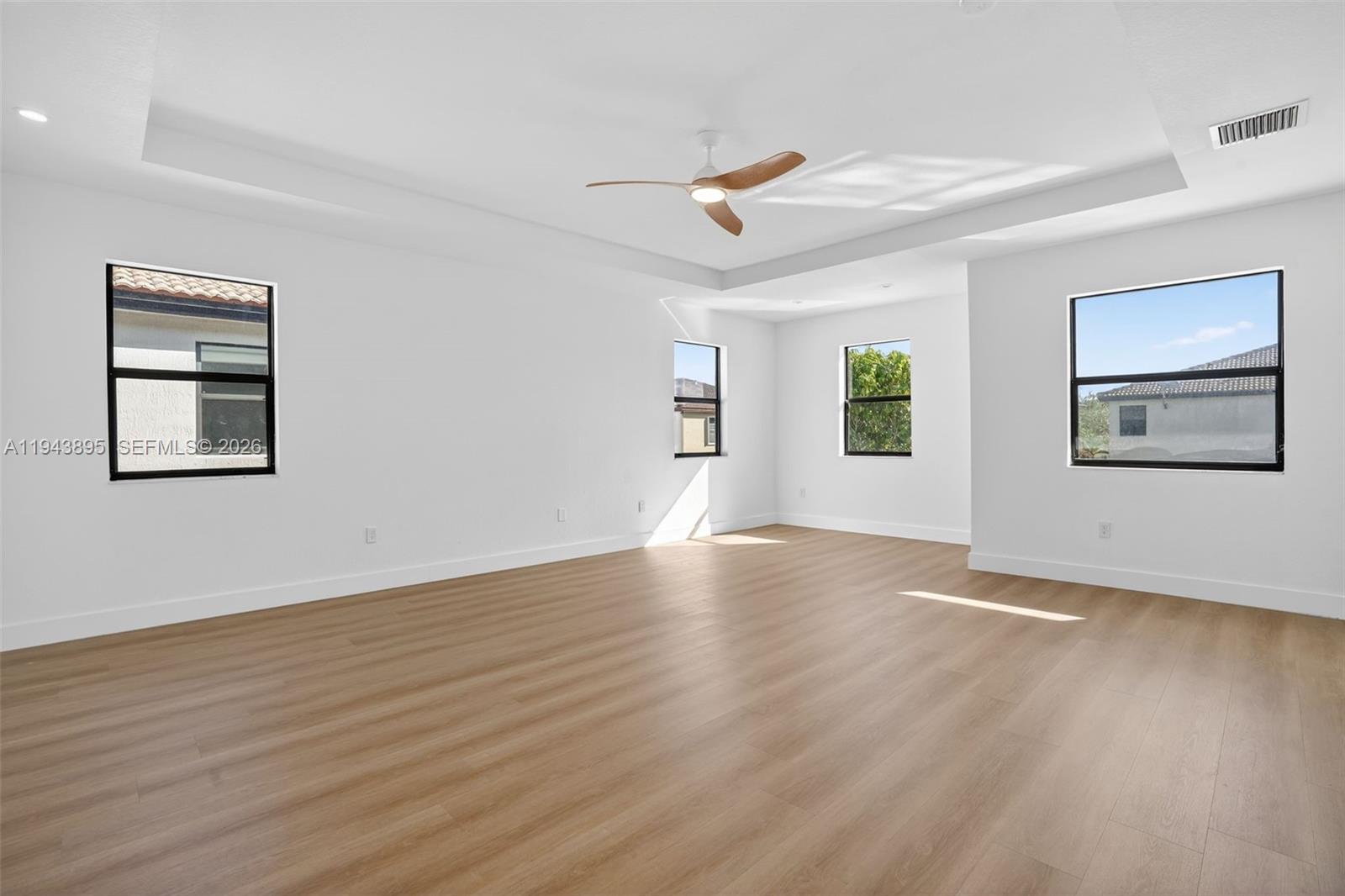 11556 Southwest 234th Street Homestead, FL 33032 - Photo 20 of 44 a view of an empty room with wooden floor and a window