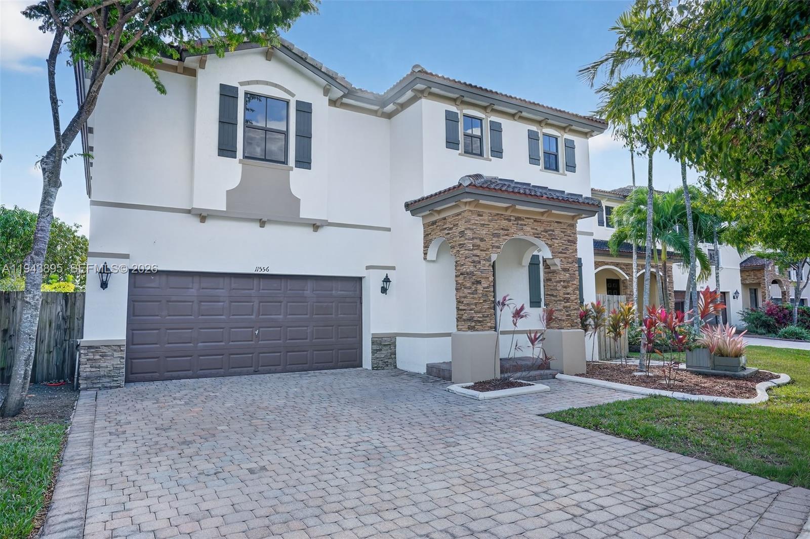 11556 Southwest 234th Street Homestead, FL 33032 - Photo 2 of 44 a front view of a house with a yard and garage