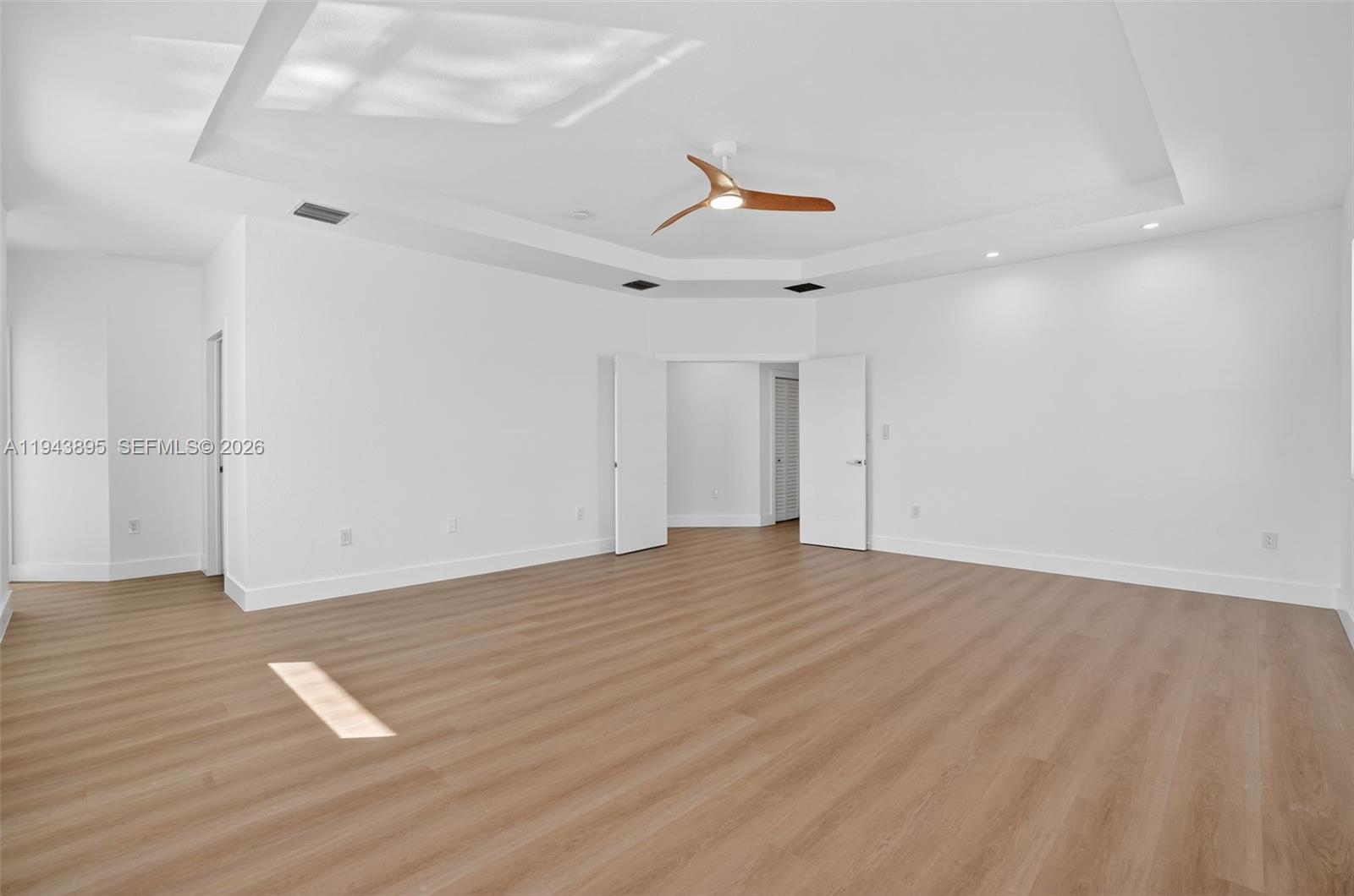 11556 Southwest 234th Street Homestead, FL 33032 - Photo 21 of 44 an empty room with wooden floor and windows