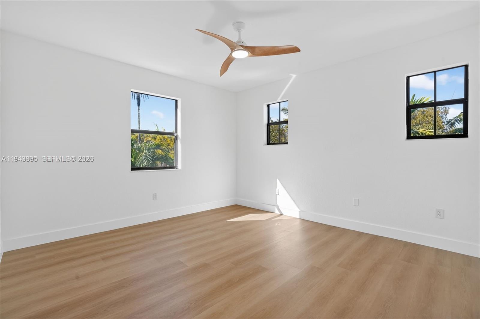 11556 Southwest 234th Street Homestead, FL 33032 - Photo 27 of 44 a view of an empty room with a window and wooden floor