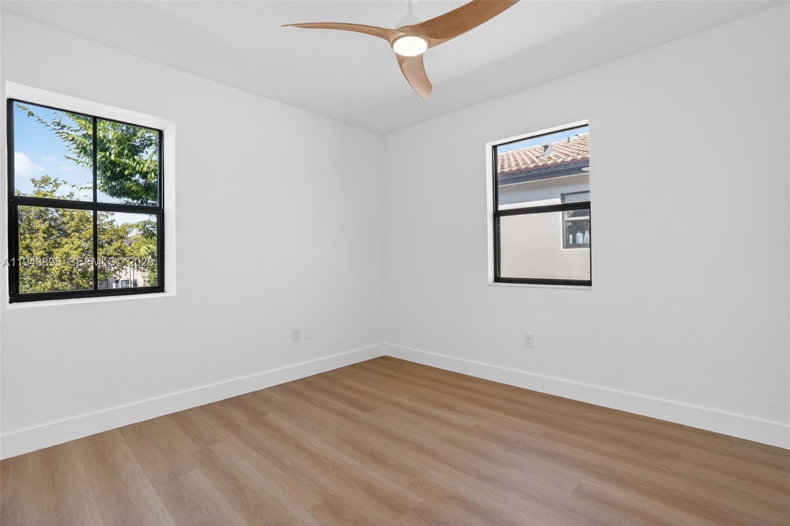 11556 Southwest 234th Street Homestead, FL 33032 - Photo 29 of 44 wooden floor in an empty room with a window
