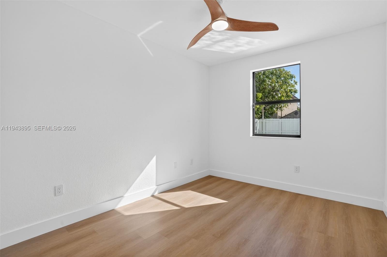 11556 Southwest 234th Street Homestead, FL 33032 - Photo 31 of 44 an empty room with wooden floor and windows