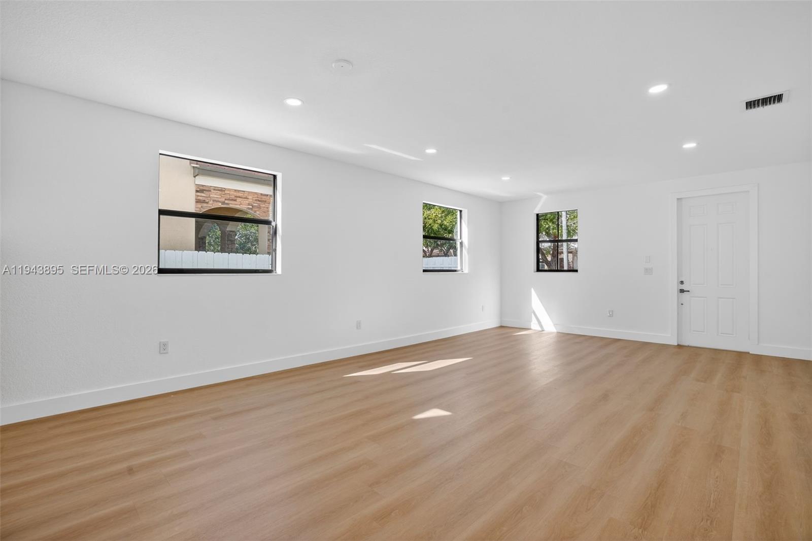 11556 Southwest 234th Street Homestead, FL 33032 - Photo 6 of 44 a view of empty room with wooden floor and fan