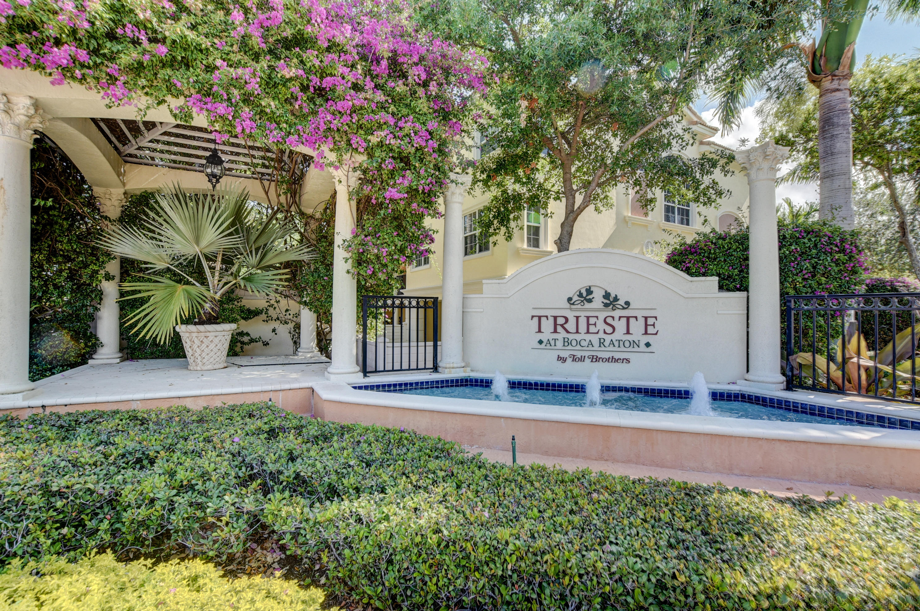 5610 Northeast Trieste Terrace Boca Raton, FL 33487 - Photo 40 of 44 a view of a sign in a yard with potted plants and tree