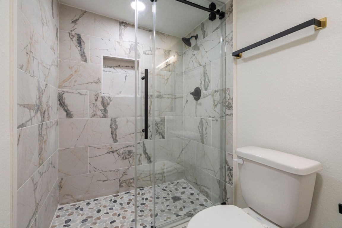 2817 Winbern Street Houston, TX 77004 - Photo 11 of 23 a bathroom with a toilet and shower