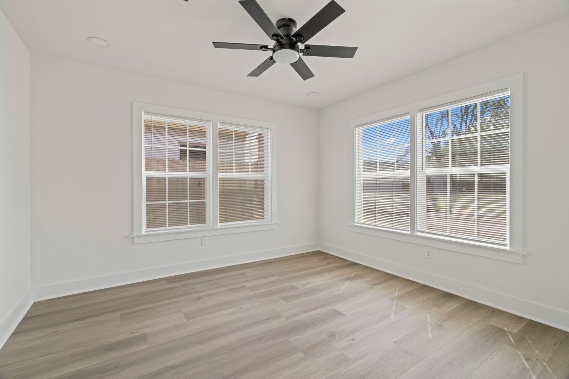 2817 Winbern Street Houston, TX 77004 - Photo 14 of 23 an empty room with wooden floor and windows